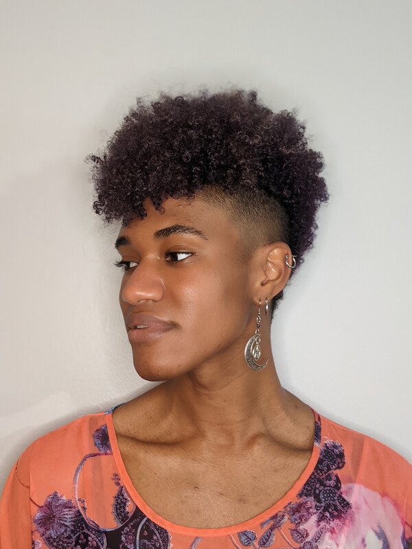 Curly cropped cut with faded sides, styled at Bohem Dreme