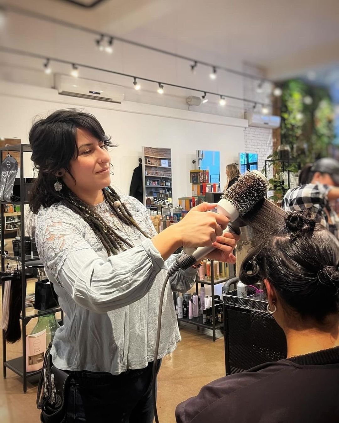 Steph styling a client's hair inside the Bohem Dreme studio